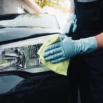 cropped view of car cleaner wiping headlamp with r 2026 01 06 00 38 42 utc